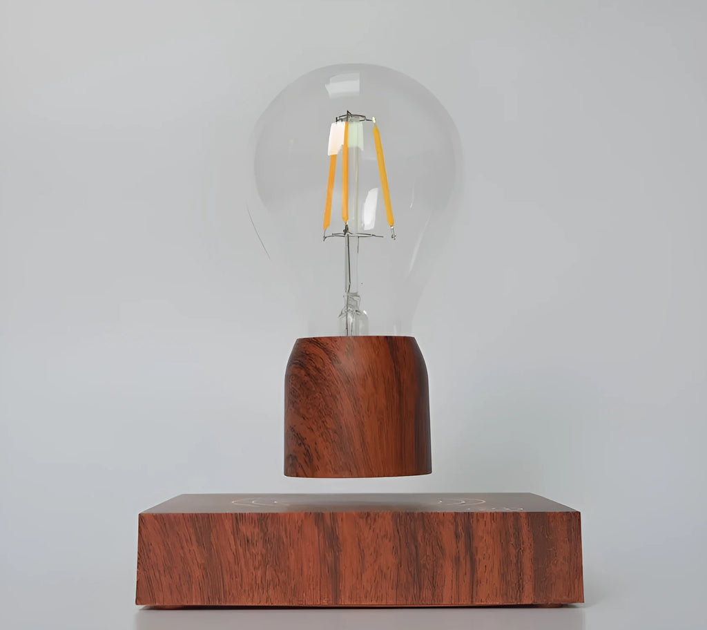 Magnetic levitating light bulb floating above an imitation wood base on a desk.