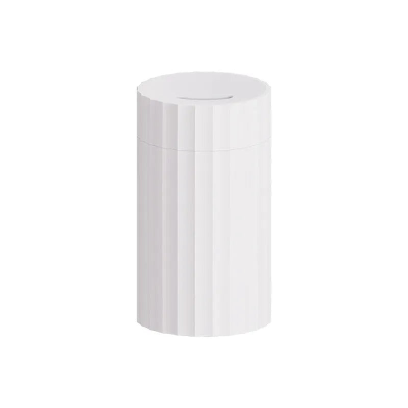 Black and white essential oil diffuser and humidifier with a simulated LED flame effect on a table.