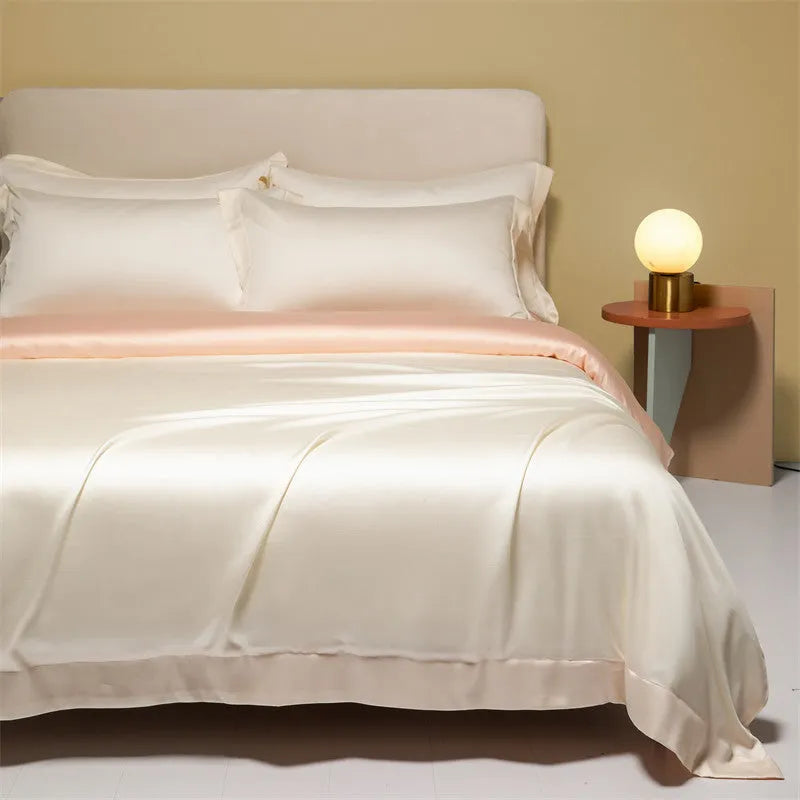 200 thread count Lenzing Tencel quilt cover and sheet set in Aurora Blue, laid on a bed.