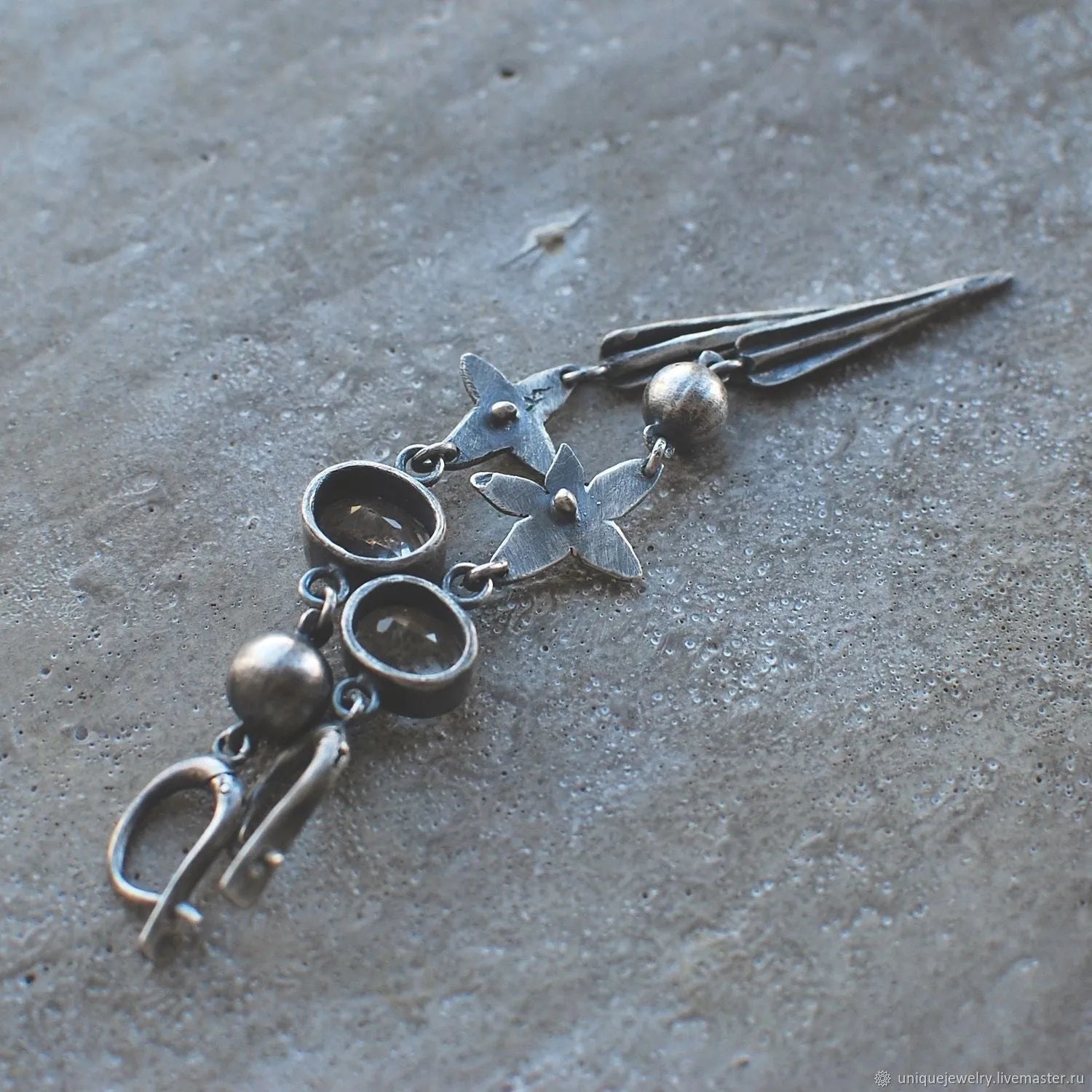 Geometric long XINGX pendant earrings in antique silver with rhinestone details on alloy.