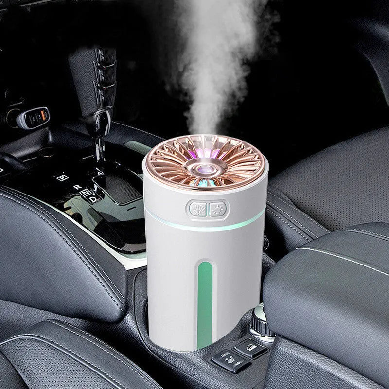 Black portable ultrasonic humidifier with colourful LED lights on a car cup holder.