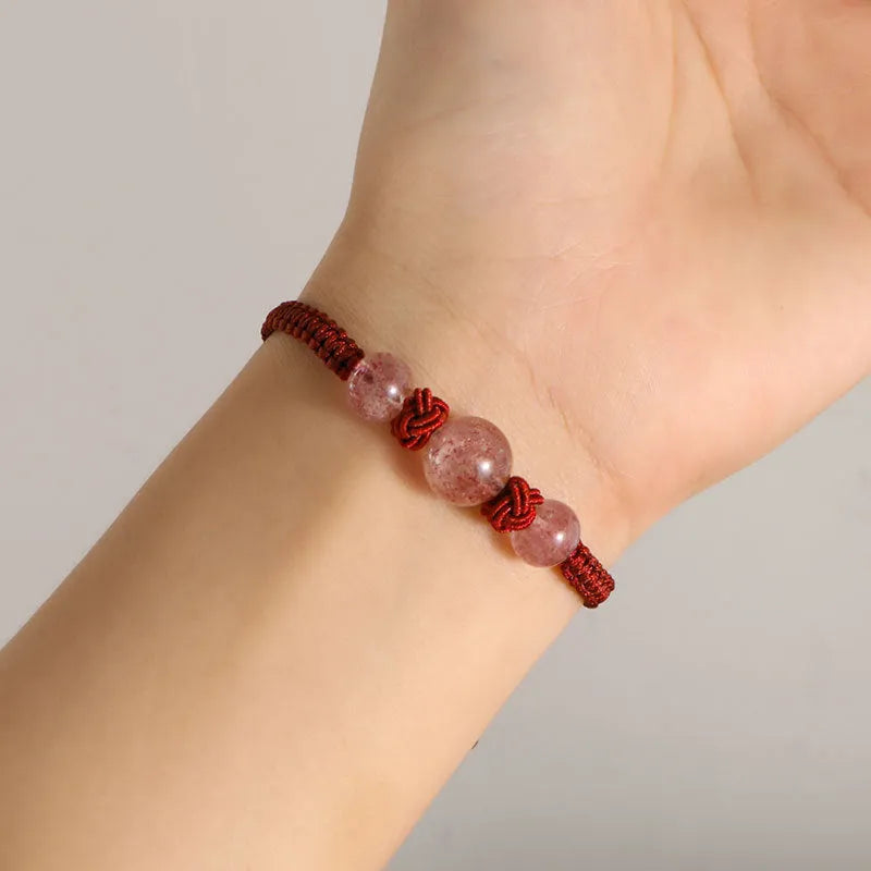 Woven red rope bracelet with natural strawberry quartz beads and alloy metal components