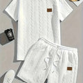 Men's black ribbed two-piece sports set with patch design on short sleeve top and matching shorts