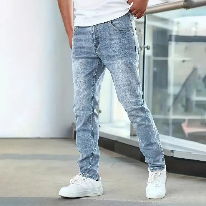 Men's slim-fit stretch jeans in dark blue on a neutral background.