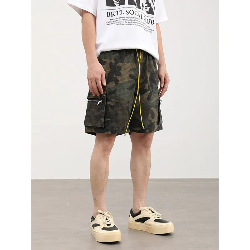 Men's camouflage cargo shorts with multiple pockets showing cropped length and mid-waist design