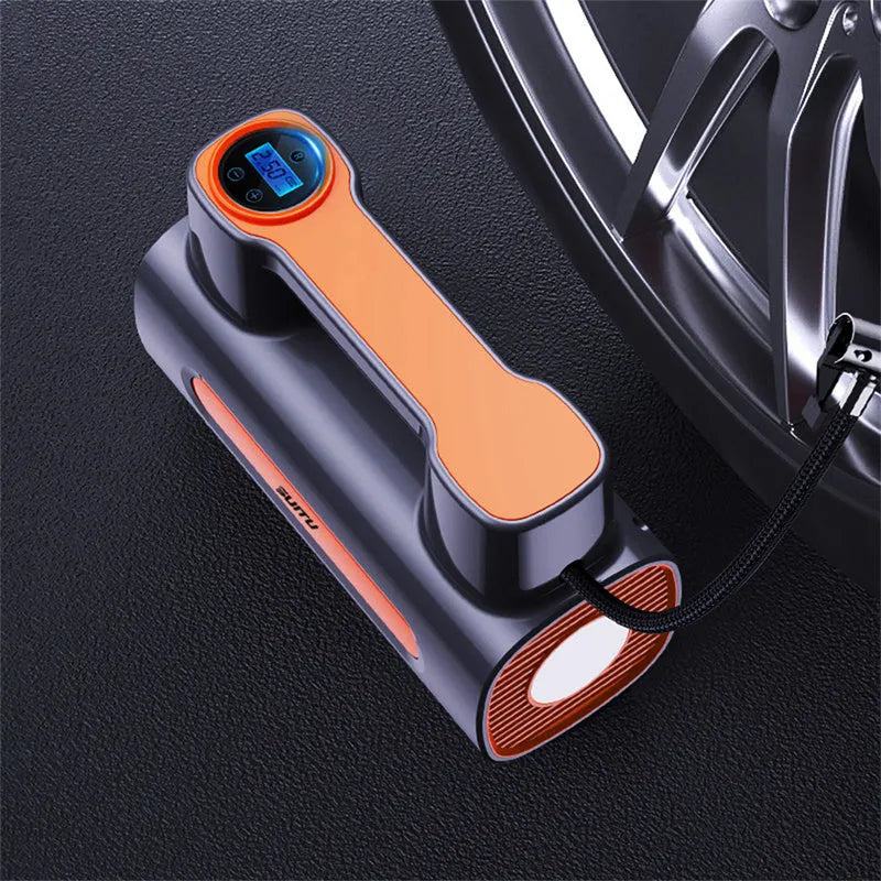 Black portable wireless tire inflator with digital display and USB charging cable on a grey background.