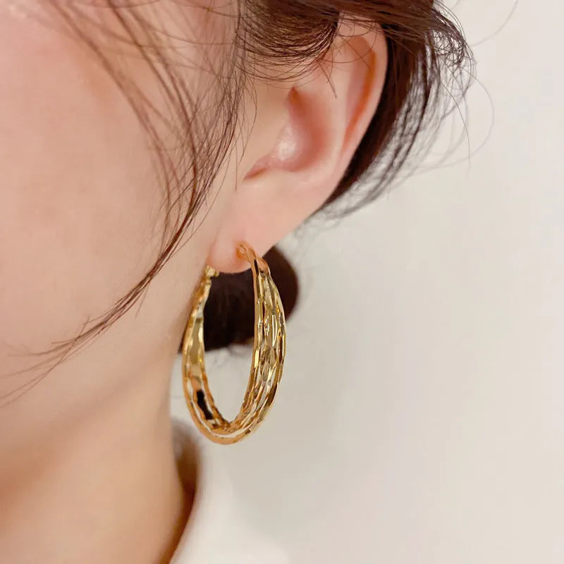 Silver Needle fashion simple metal twisted earrings in gold electroplated finish on copper base, round geometric shape