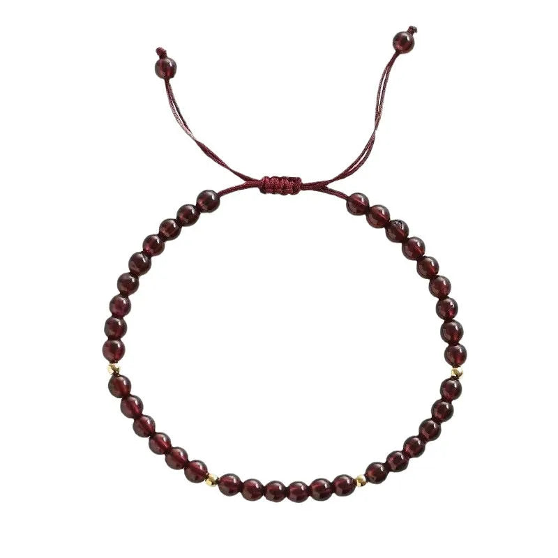 Hand-woven red rope garnet bracelet on a wrist, showing flexible wire and new Chinese style.