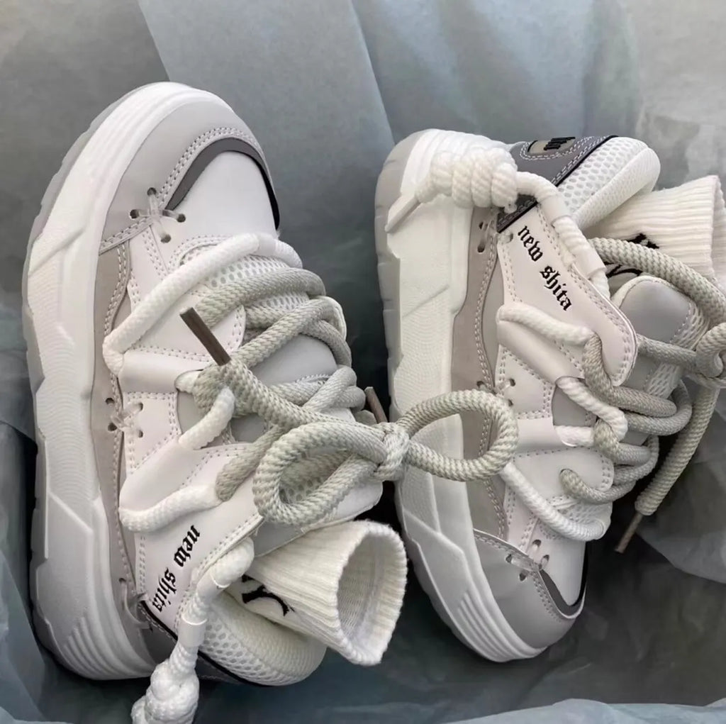Women's grey retro chunky sneakers with thick rubber platform sole and lace-up front.