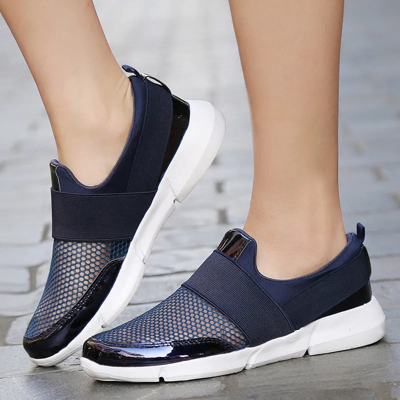 Blue, black, and grey women's low-top sneakers with mesh interior and casual design.