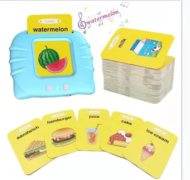 Blue children's learning machine with audio book cards on a table