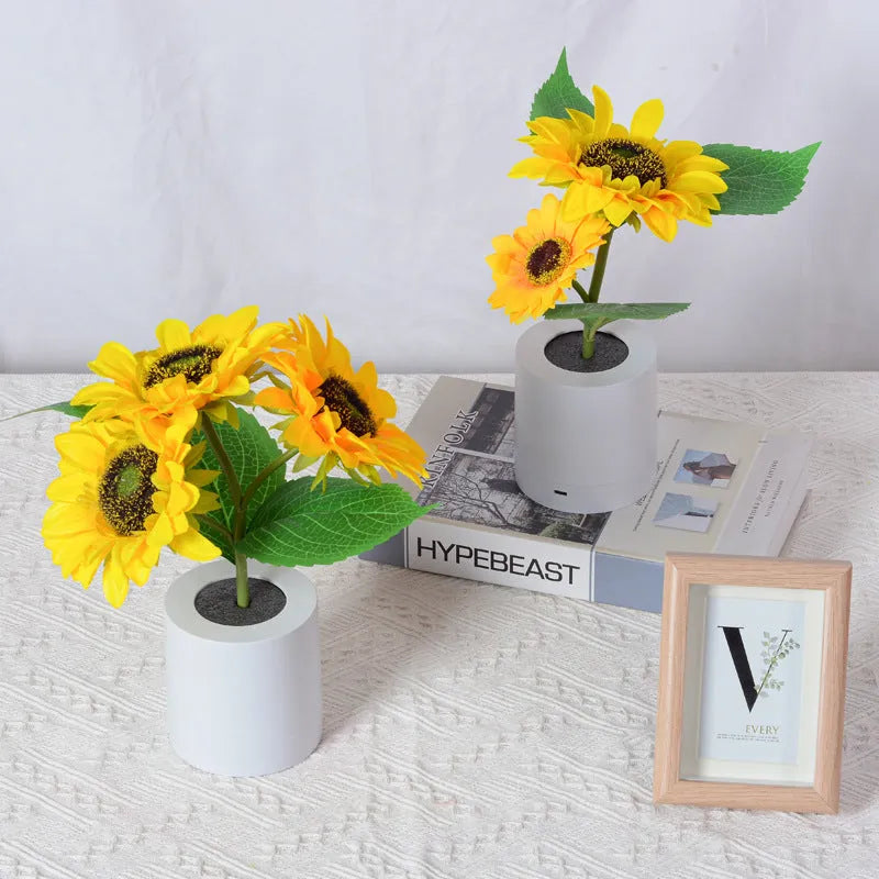 Sunflower LED night light with artificial flowers on wooden table