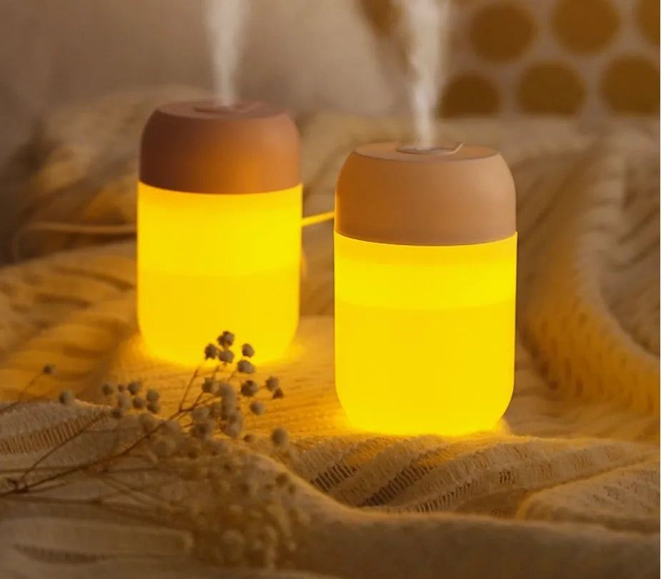 Small white cylindrical USB humidifier with aromatherapy function on desk