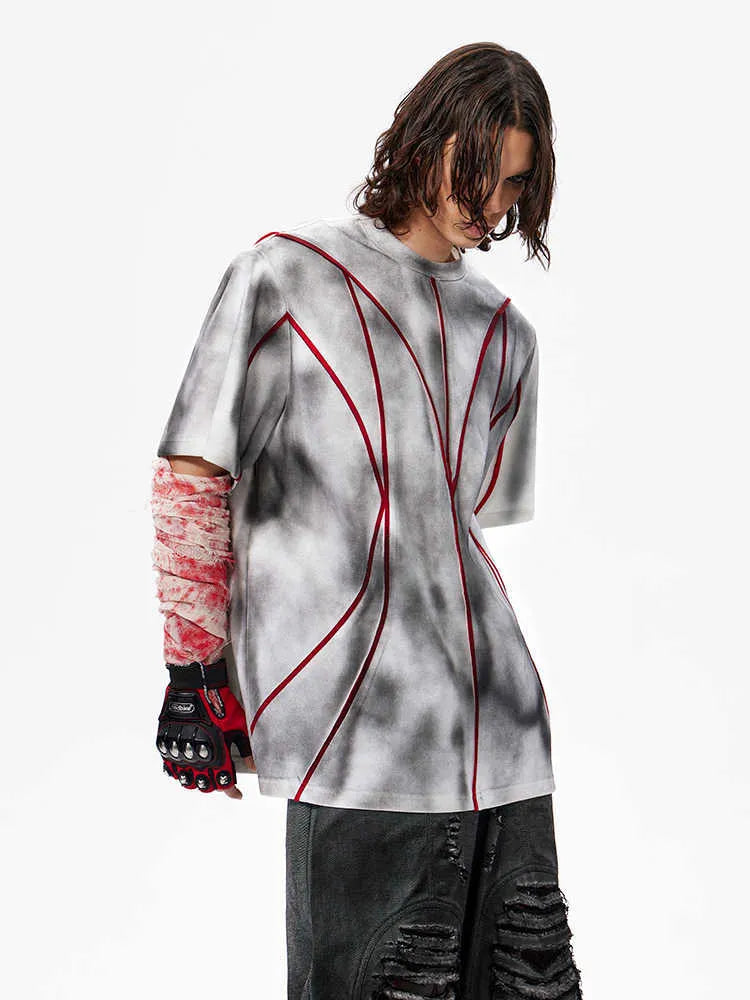Short sleeve T-shirt with padded shoulders and three-dimensional line patchwork detail on a round neck
