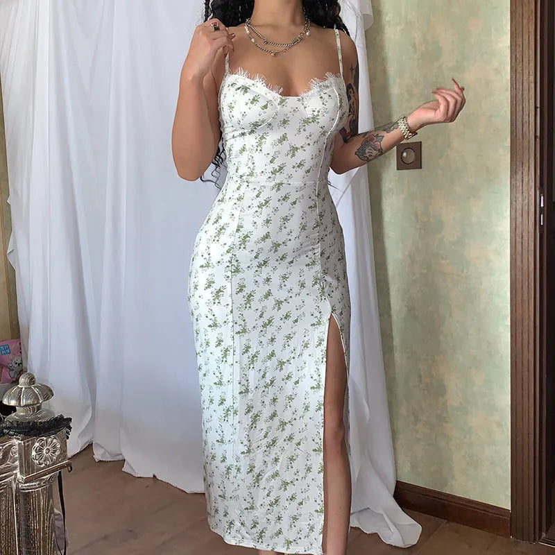 Women's long blue summer dress with lace flowers print, suspender straps, and a side slit.