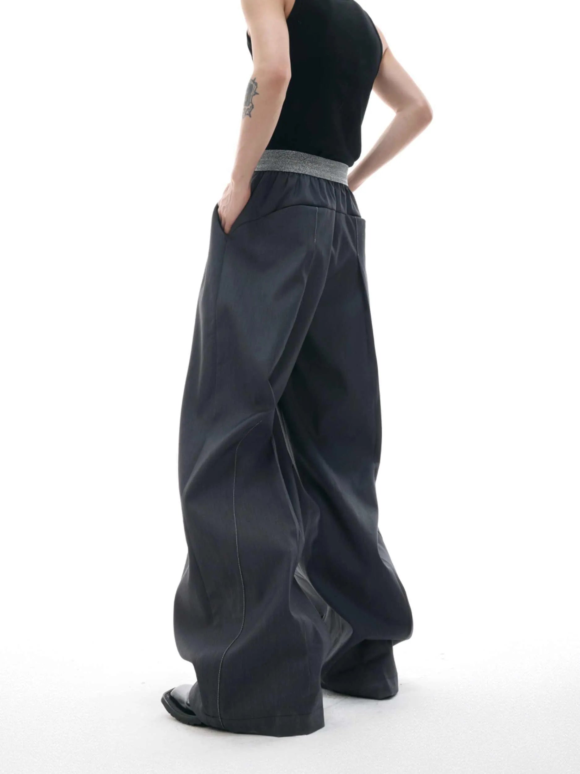 Black high-waisted straight-leg casual trousers featuring a button-open line design detail on the leg.