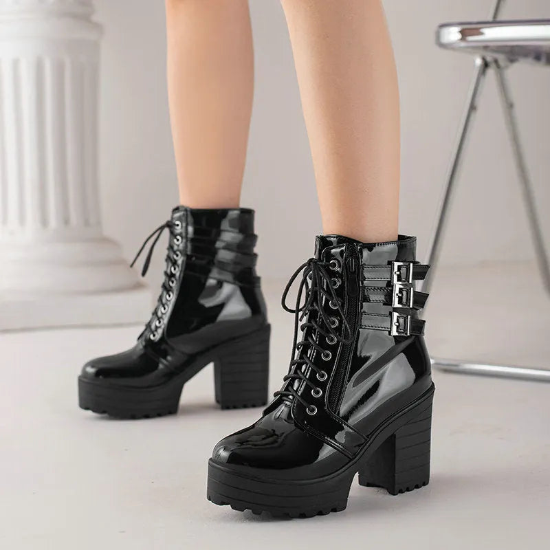 Women's black thick heel ankle boots with round toe and front lace-up on a waterproof platform.