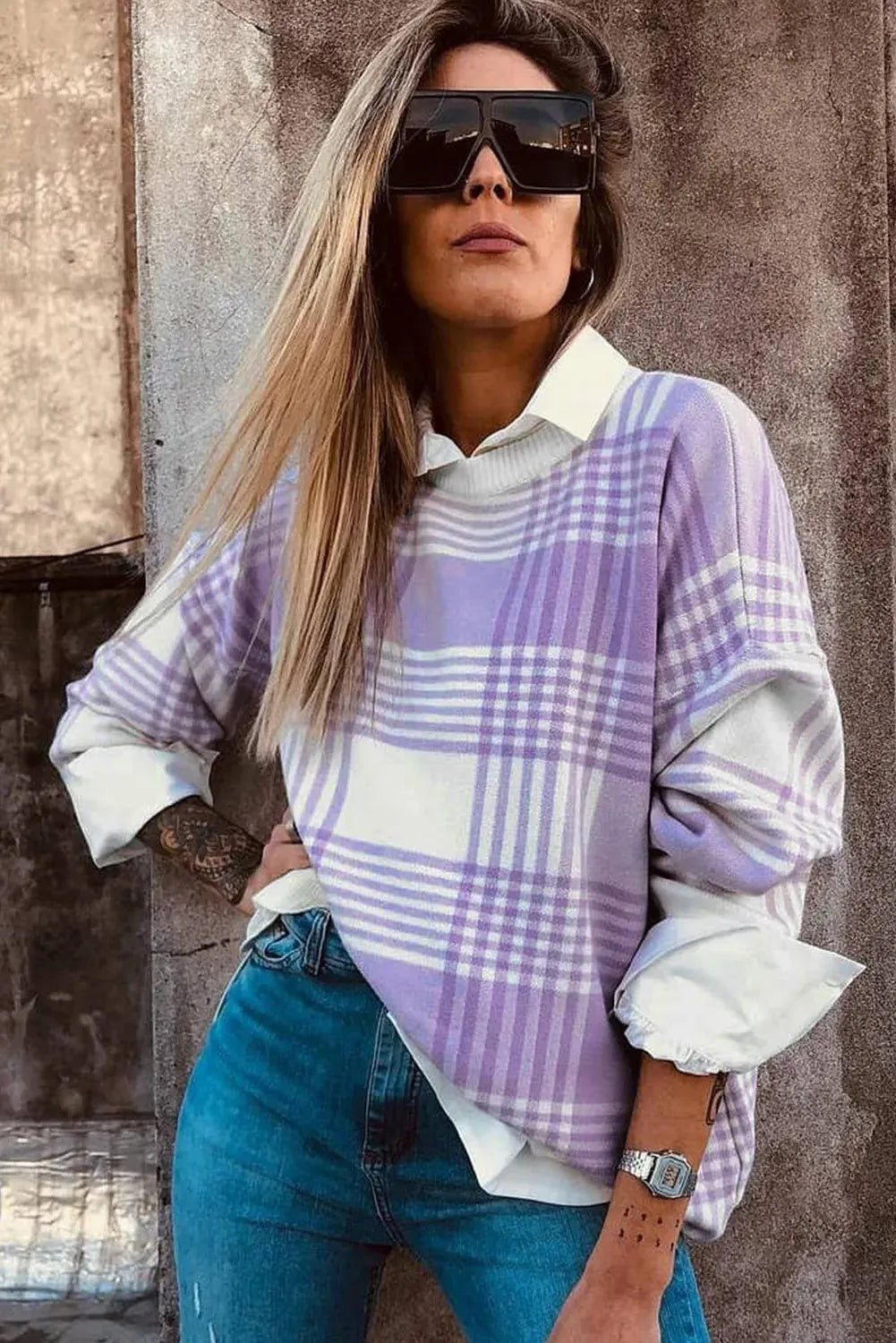 Lilac plaid print loose knit sweater with ribbed cuffs and hem on a hanger.