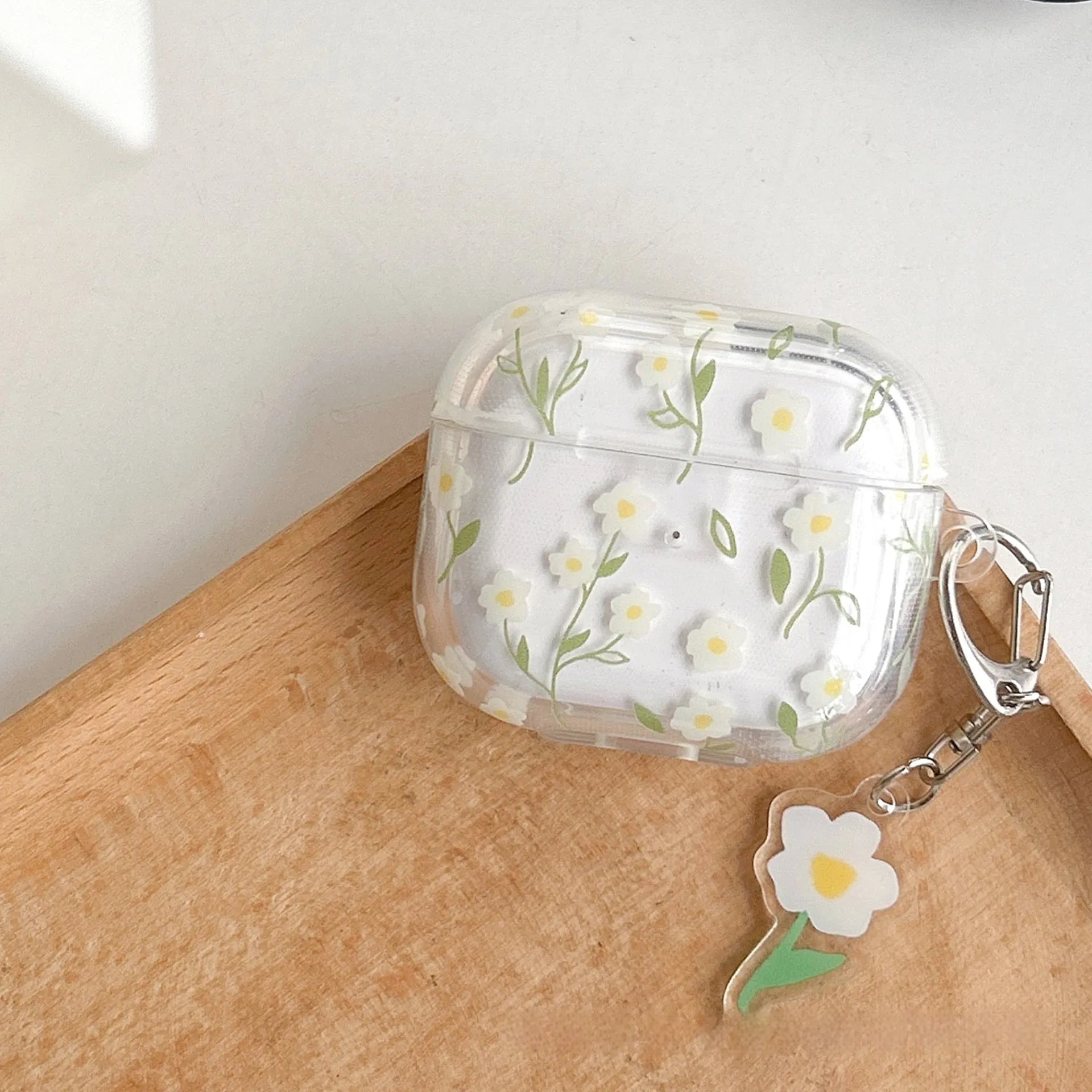 White floral high-transparency TPU protective cover for Apple AirPods showing decorative patterns