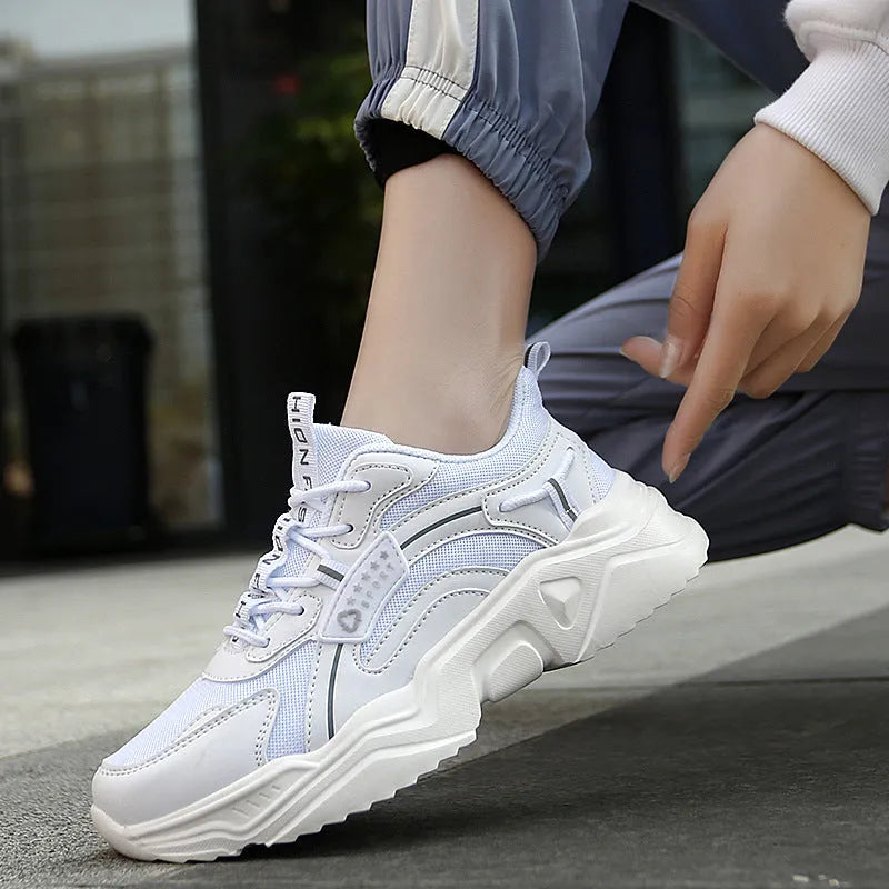 Women's white and black mesh casual sports shoes with thick sole, buckle closure, and round toe.