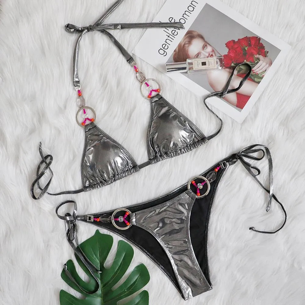 Silver women's two-piece bikini swimsuit with high-cut briefs on a mannequin.