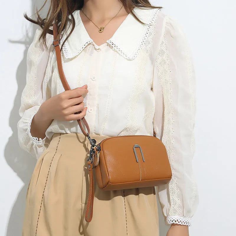 Women's black genuine leather shoulder bag showing square shape and compact 19x13x6cm size