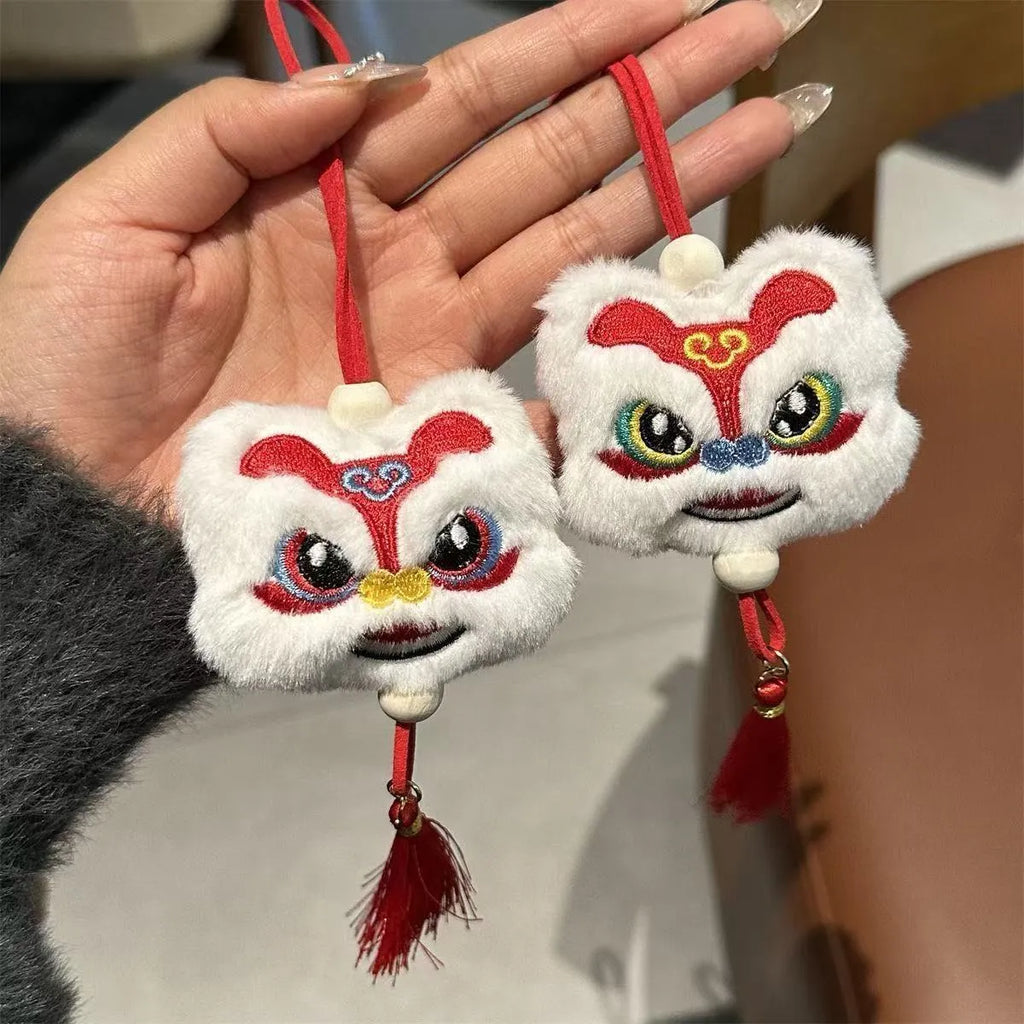 Blue and yellow handmade plush lion keychains with star stone decoration on a cartoon style tassel ornament.