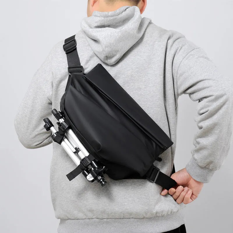 Grey PU leather men's crossbody sling backpack with zip and adjustable strap.