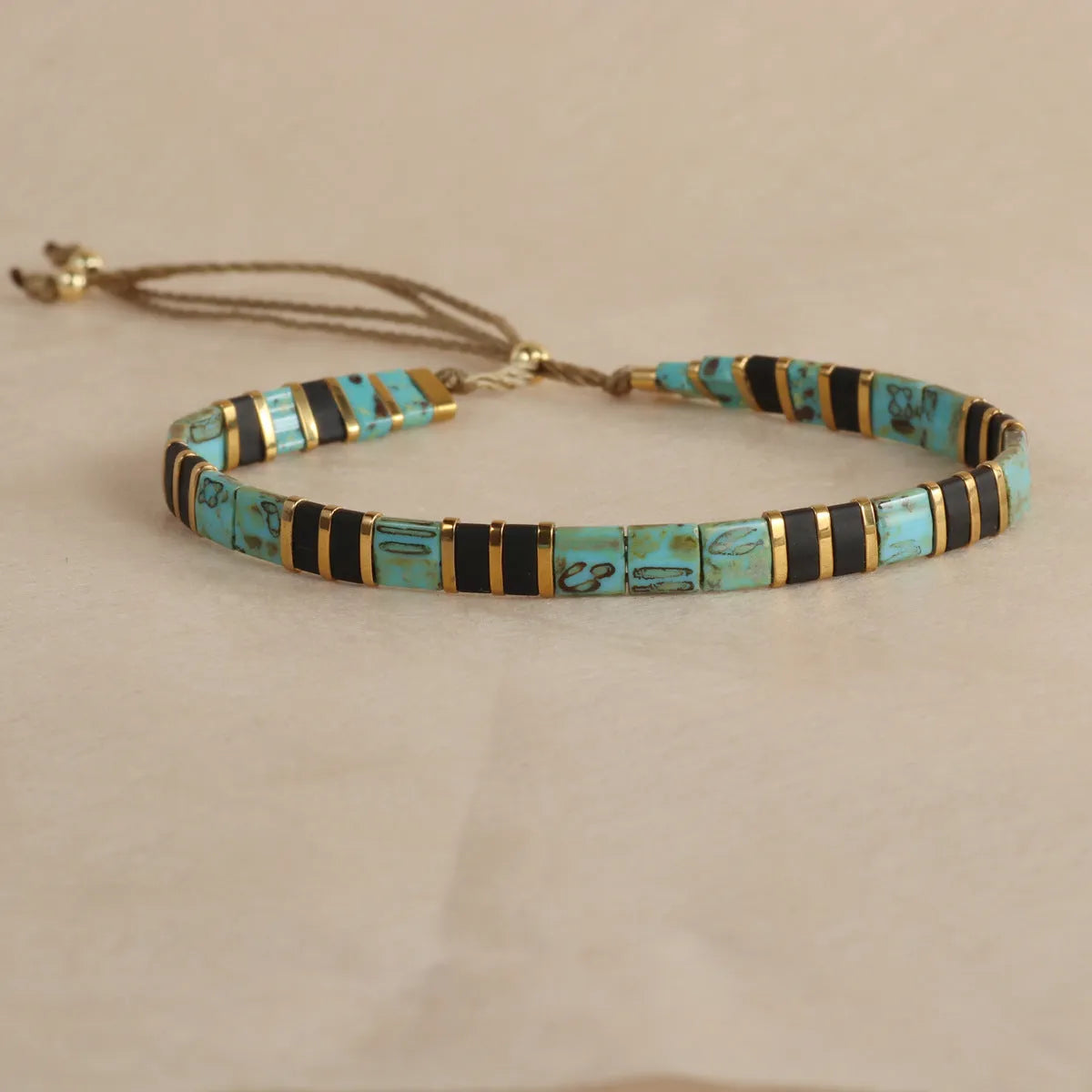 Geometric glass bead bracelet in milky white, black, retro green, light blue, or red colours.