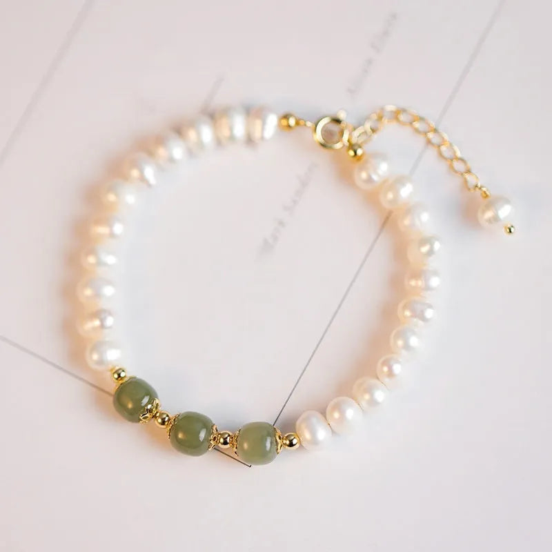 Natural freshwater pearl bracelet with diamond-shaped beads in Hetian jade colours on wrist