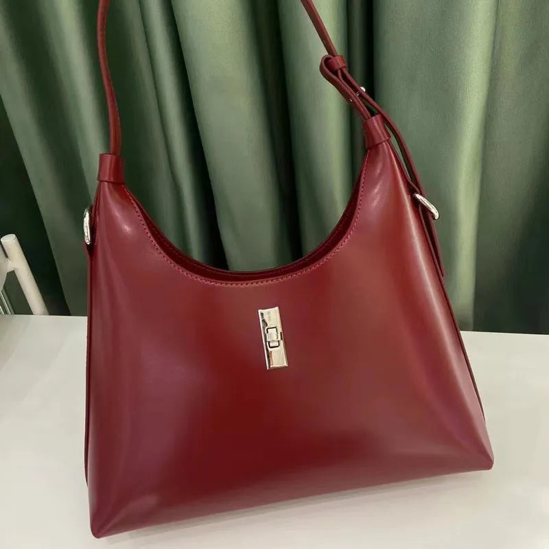 Genuine leather dumpling-shaped crossbody shoulder bag in apricot colour with street-trend details.