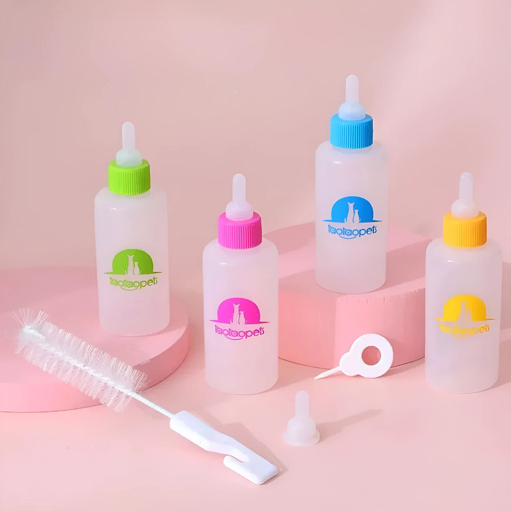 Set of four coloured pet milk bottle feeders with silicone teats and a cleaning brush for small animals.