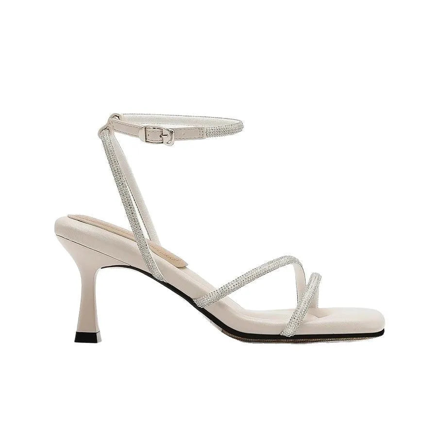Women's silver rhinestone ankle-strap sandals with a square toe and buckle fastening.