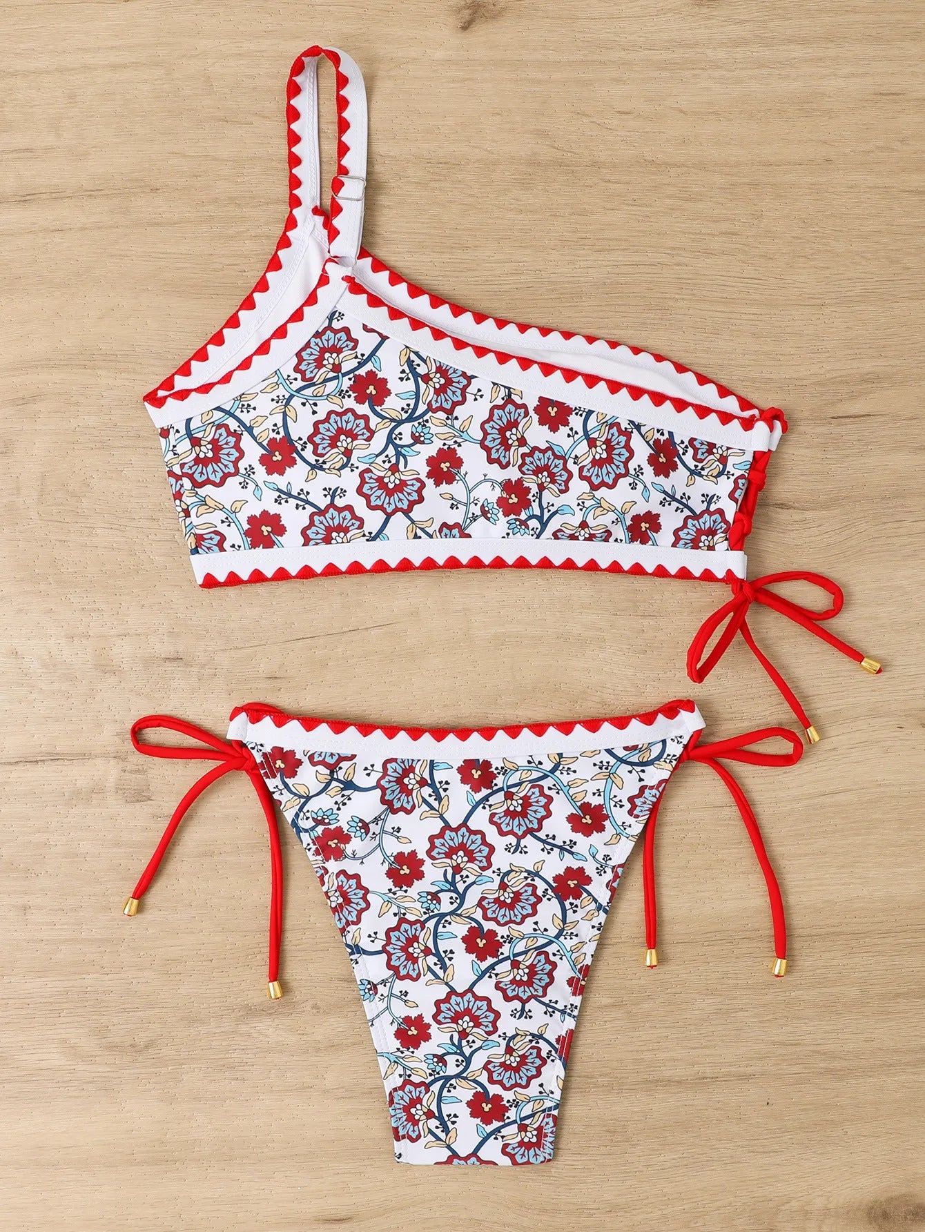 Blue one-shoulder floral bikini set with brief bottoms on mannequin