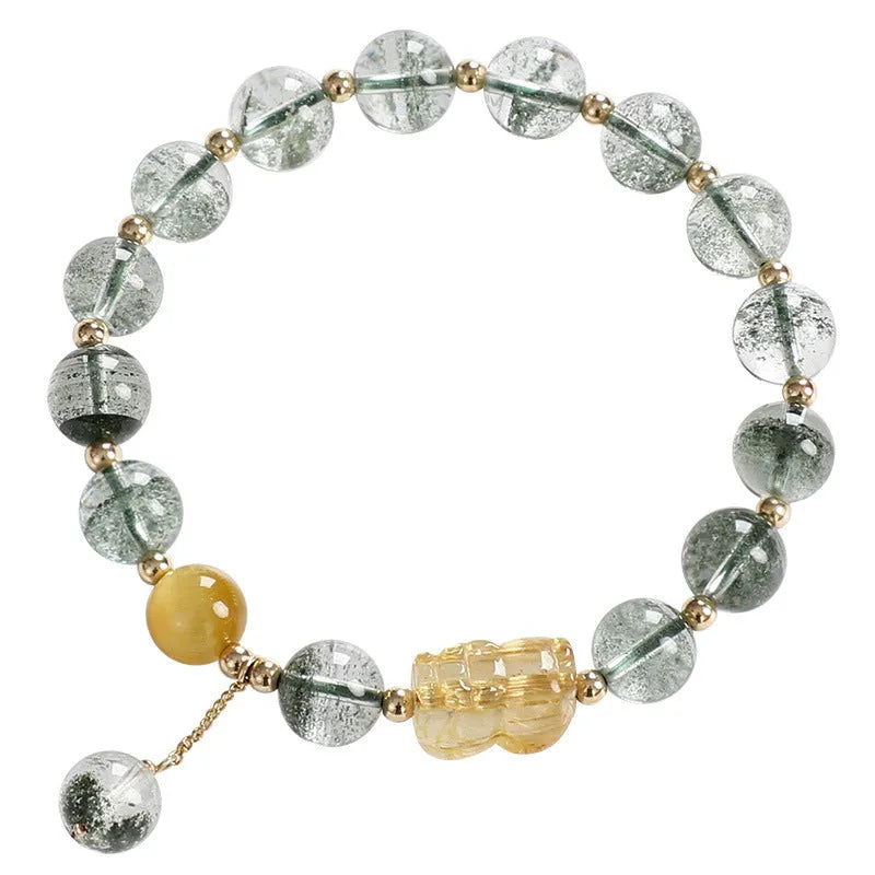 Green phantom quartz bracelet with 8mm geometric beads and gold rutile inclusions on wrist