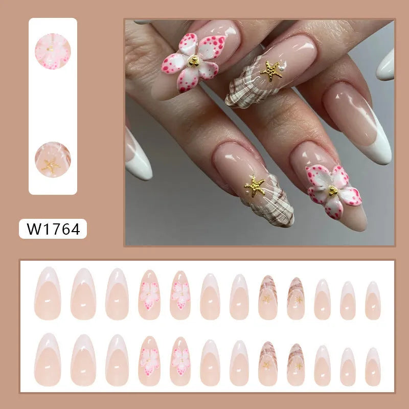 French style false nails with rock pattern and simple W1764 flower design in a plastic kit.