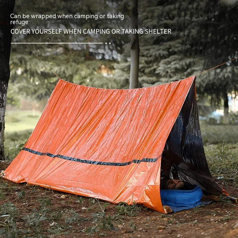 Orange and green portable disaster relief tent with sleeping bag and emergency blanket set.