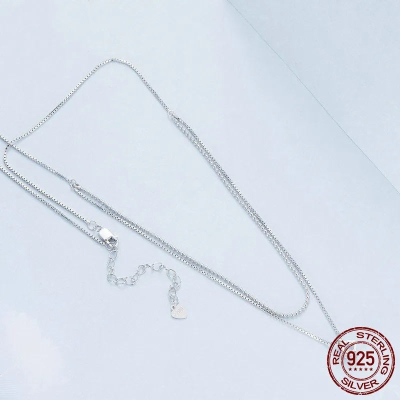 Close-up of a women's double-layer pearl chain necklace in S925 sterling silver with a shining pendant.