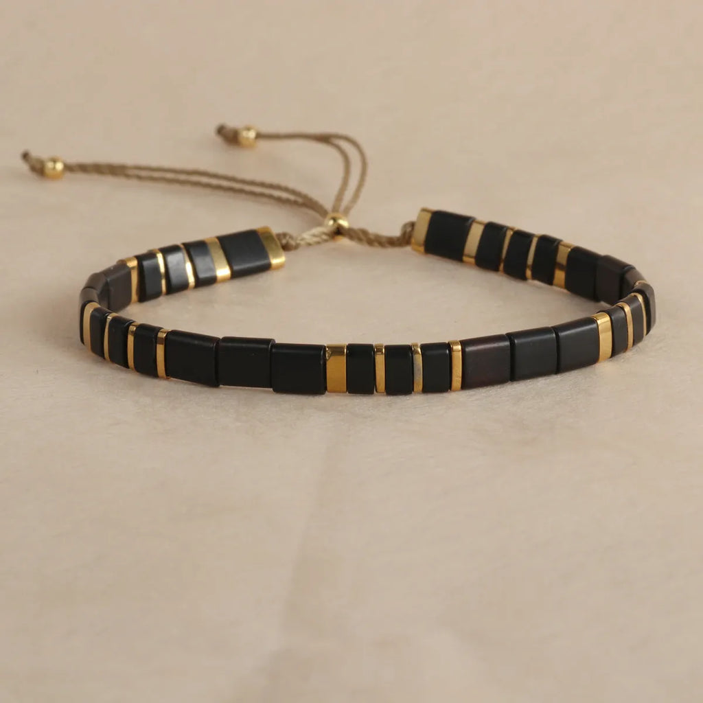 Geometric glass bead bracelet in milky white, black, retro green, light blue, or red colours.
