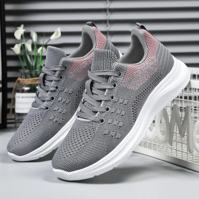 Women's low-top lace-up sneakers in black mesh with a soft PVC sole.