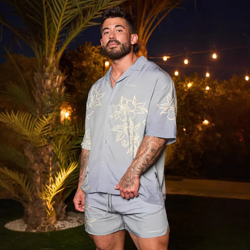 A loose-fitting short sleeve casual top with a floral print, shown in a light colour on a male model.