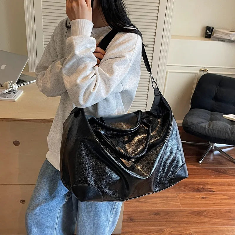 Black hand-carry travel bag for women with large 36-55 litre capacity