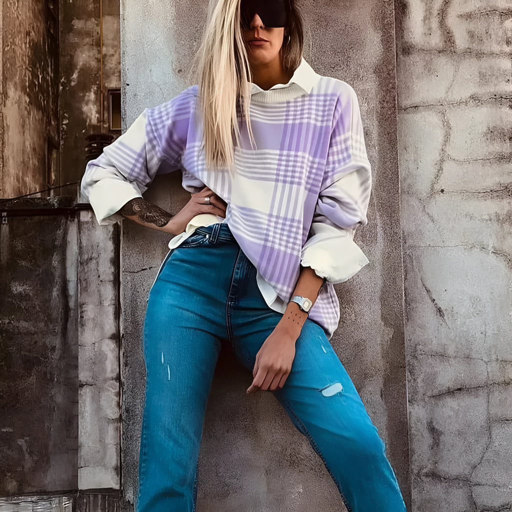 Lilac plaid print loose knit sweater with ribbed cuffs and hem on a hanger.