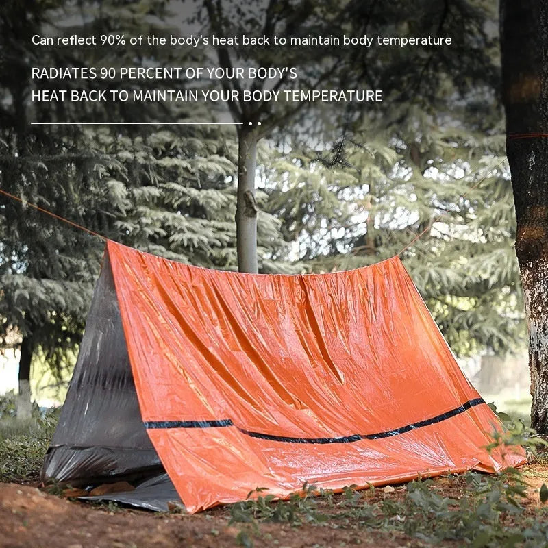Orange and green portable disaster relief tent with sleeping bag and emergency blanket set.