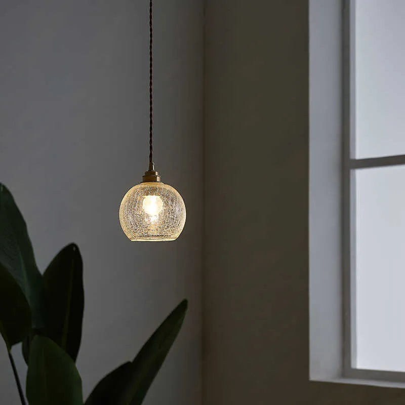 Brass and glass ball chandelier with spherical shade and metallic body