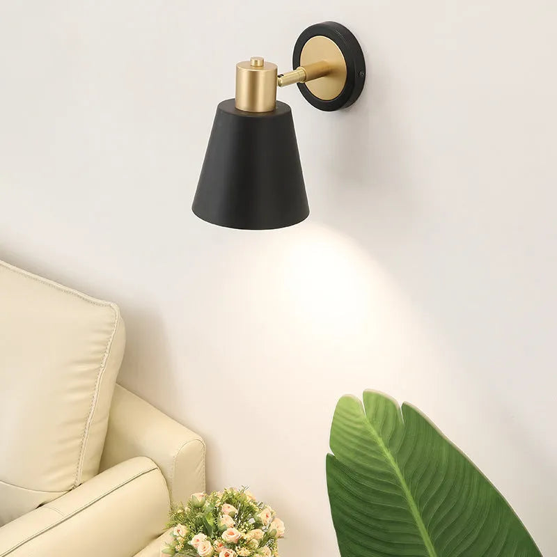 Nordic style iron wall lamp with a metallic shade for bedside or living room.
