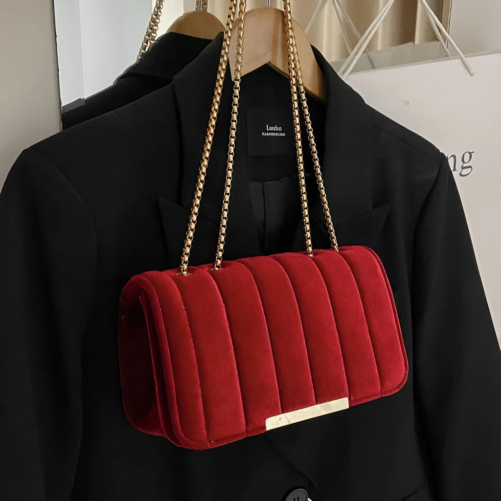 One shoulder velvet chain crossbody bag in solid colour, small square shape with gold chain strap, on white background.