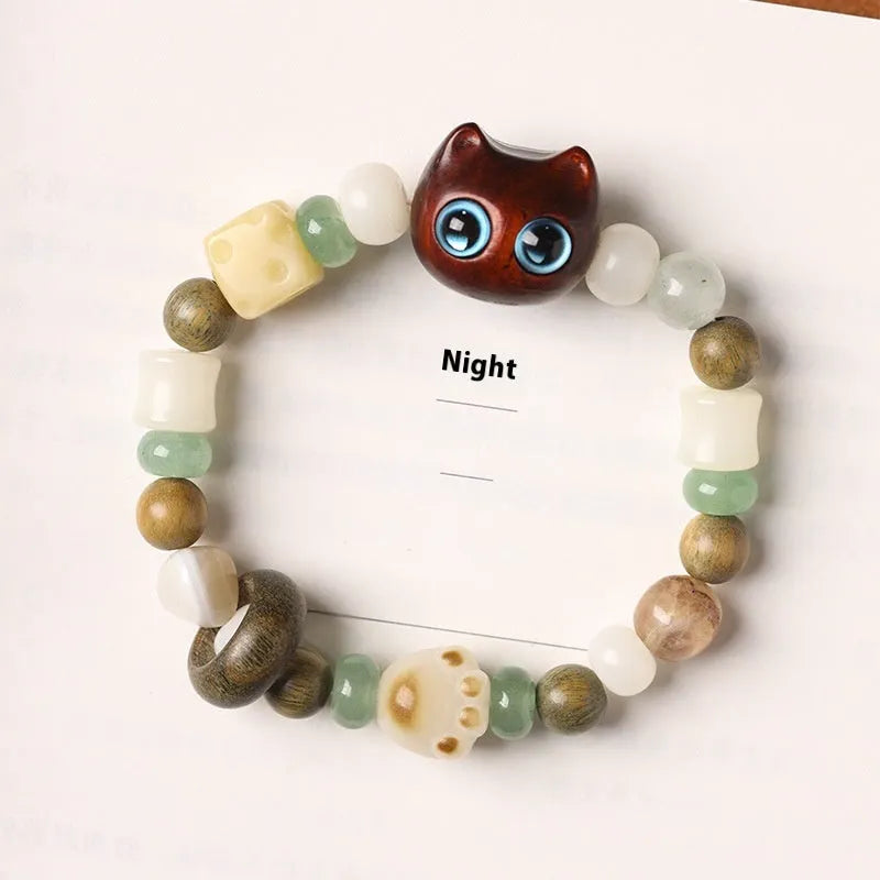Hand-woven bracelet with jade guajacwood multi-treasure cube and cat's paw design in bodhi and ebony materials