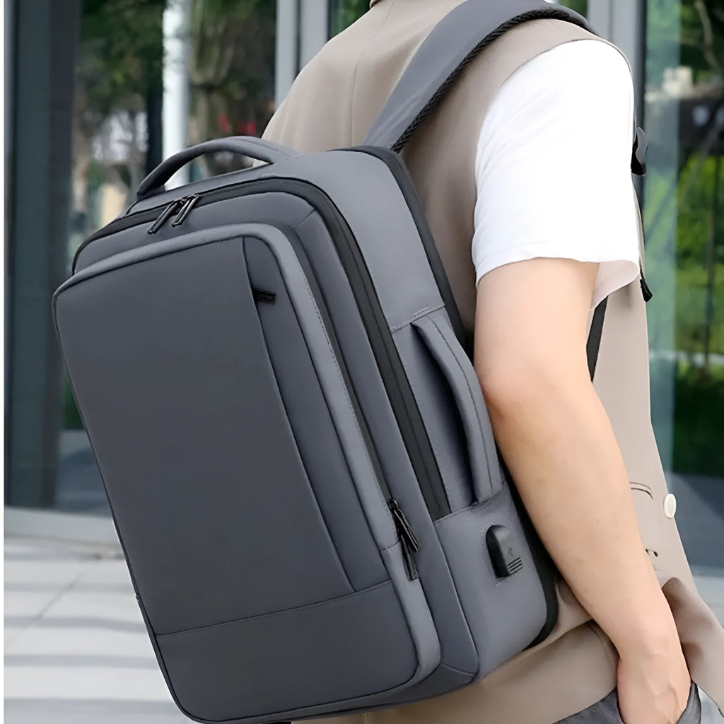 Black large capacity Oxford cloth men's backpack with curved shoulder strap, shown for business and travel use.