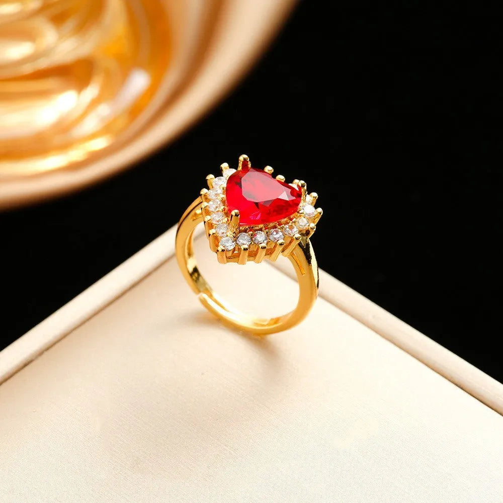 Gold red titanium steel necklace, earrings, and ring set with heart flower pendant.